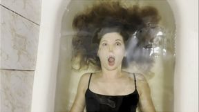 Milana training her breath in bathtub with her eyes open