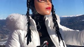 Rubber lipstick finish Rubbermissy in ski gondola dressed in rubber with latex mask, corset, latex gloves