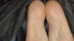 Feet hidden under the wool blanket and yet found