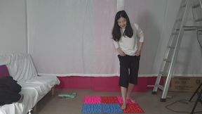 Domi steps onto a foot massager mat and suffers