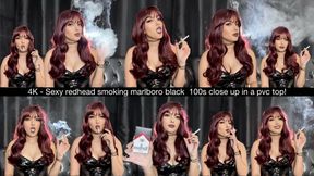 4K - Sexy redhead smoking Marlboro Black 100s close up in a pvc top!