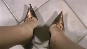 Tara dangling in gold pumps