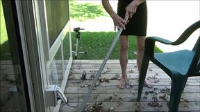 Lilly sweeping the porch barefooted