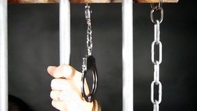 Arianna handcuffed to the bars 1