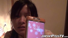 Japanese chick wakes up and pees in a jar while on the floor