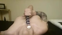 Sexy Girl Rubs a Glass Dildo on Tits