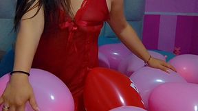 Playing with pink heart balloons