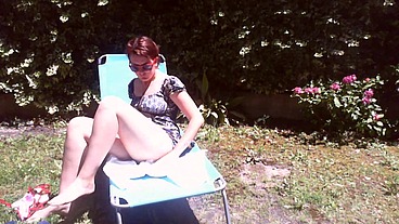 Italian girl sunbathing in a public garden with a big dirty diaper