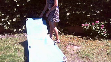 Italian girl sunbathing in a public garden with a big dirty diaper
