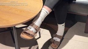 Shoeplay and dangling in Birkenstock sandals , white Nike Crew socks and leggings in public