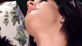 A sultry, raven-haired vixen servicing a massive, hard phallus with skillful motions