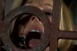 Caged blonde gets her pussy toyed after enduring some tortures