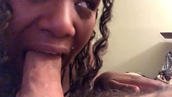 Ebony whore loudly slurps on white cock