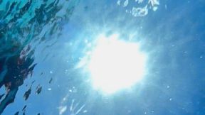 Underwater view from below with self-touch and bubbles in face and on chest