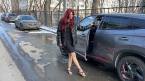 A girl in sandals and nylon stockings decided to clean the interior of the car, first she played with the pedals, and then began to clean the interior with her feet