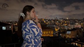 Smoking on the balcony with a city view