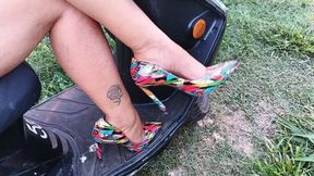 Mounted on her motorcycle she lets her stiletto heels dangle (3)