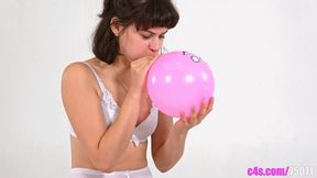 Watch Petra in white lingerie struggle to inflate a pink balloon, only for it to pop unexpectedly! (Mobile quality)