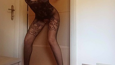In a nylon catsuit and high heels I suck a cock and fuck it in a gloryhole until it cums in my mouth