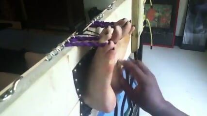 Bare feet tickling in stocks