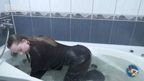 Sabrina in jeans and a jumper in the bathtub