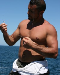 two fishermen fuck in ass a young tourist outdoor on the beach photo