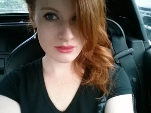 Pink lips, red hair, and pale skin.