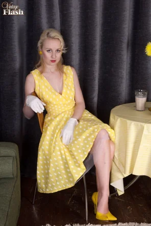 Blonde woman Kiana doffs a retro dress before masturbating in tan nylons
