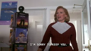 In The Truman Show, the travel agent kept Truman waiting because she has never needed to show up for work before. Also she is still wearing her makeup