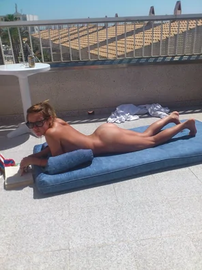 Enjoying a good book while sunbathing